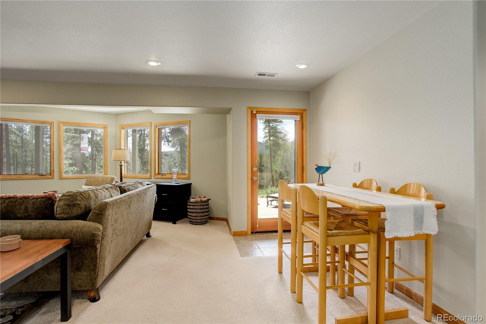 8360 South Warhawk Road Conifer, CO 80433 - Photo 29 of 40 a living room with furniture and a large window