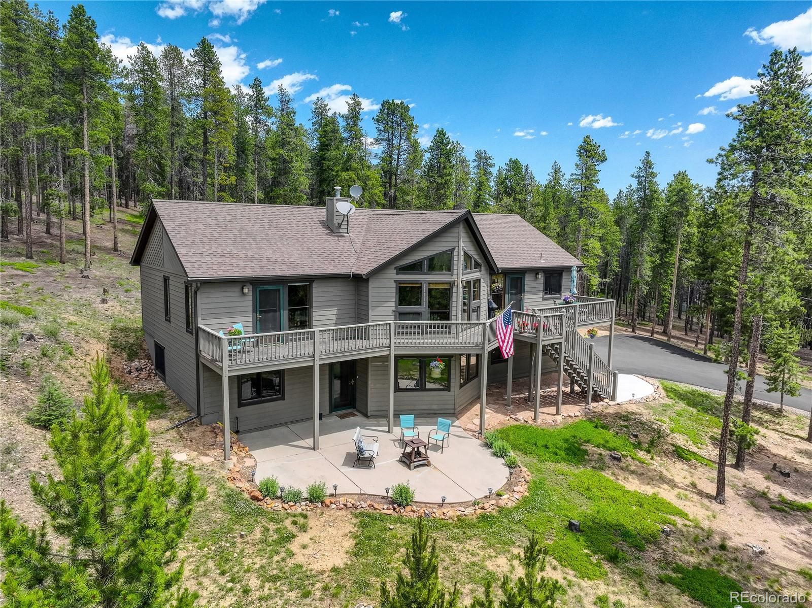 8360 South Warhawk Road Conifer, CO 80433 - Photo 3 of 40 a view of a house with backyard porch and sitting area