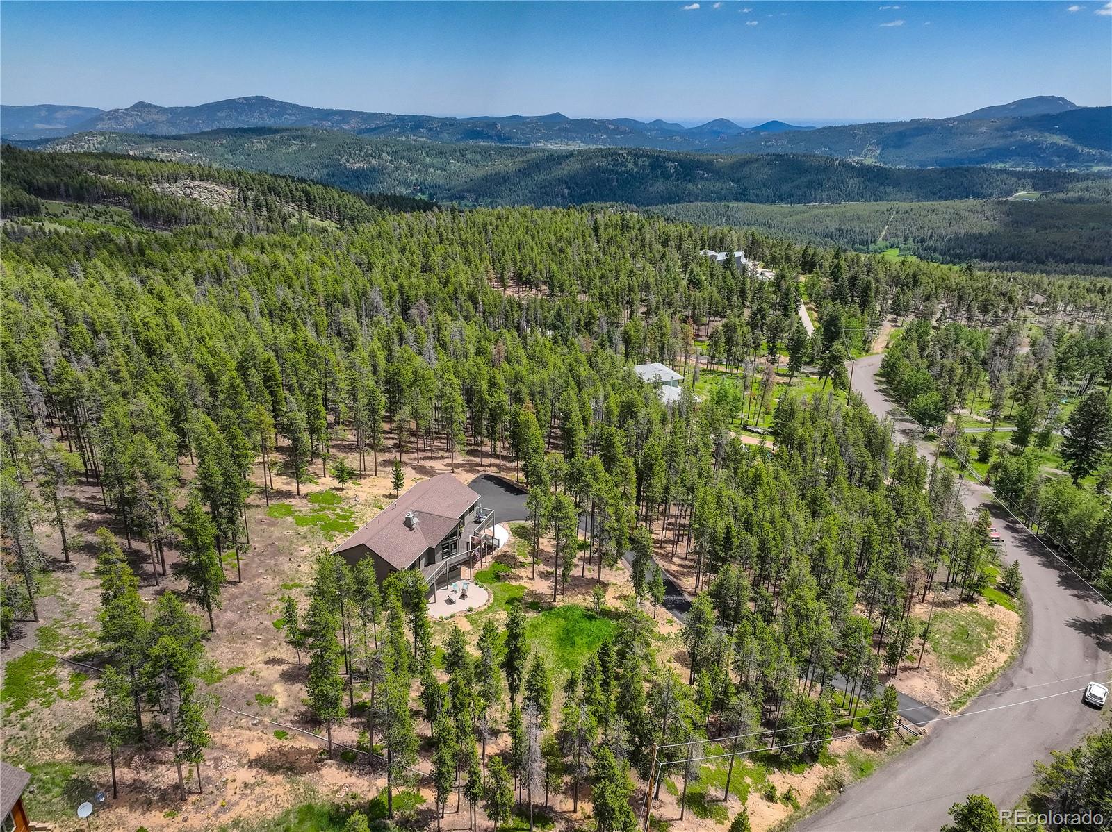 8360 South Warhawk Road Conifer, CO 80433 - Photo 38 of 40 a view of a lush green hillside and houses
