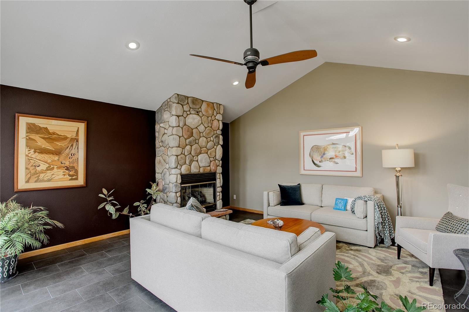 8360 South Warhawk Road Conifer, CO 80433 - Photo 9 of 40 a living room with furniture and a flat screen tv