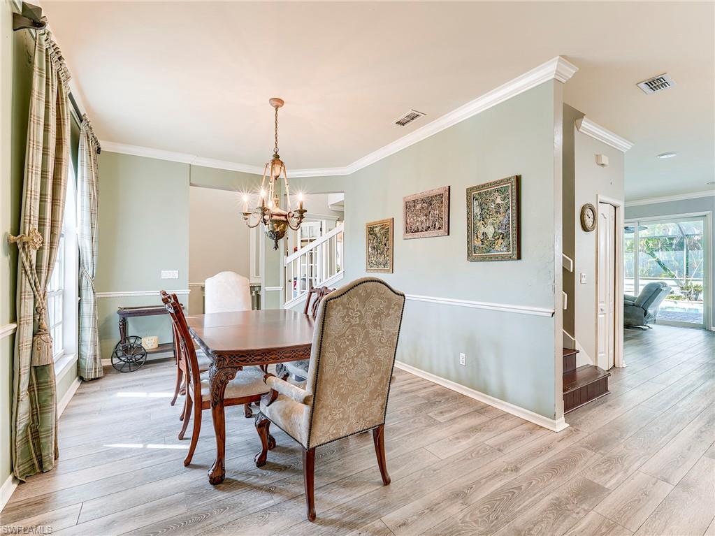 21281 Braxfield Loop Estero, FL 33928 - Photo 13 of 42 a dining room with furniture a chandelier and wooden floor