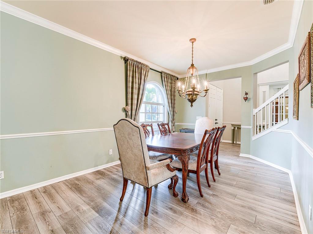 21281 Braxfield Loop Estero, FL 33928 - Photo 14 of 42 a dining room with furniture a chandelier and wooden floor