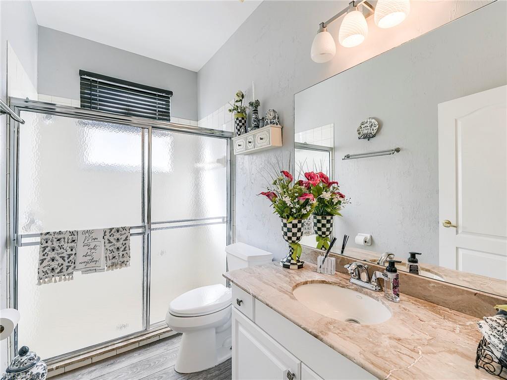 21281 Braxfield Loop Estero, FL 33928 - Photo 15 of 42 a bathroom with a sink a toilet and a mirror