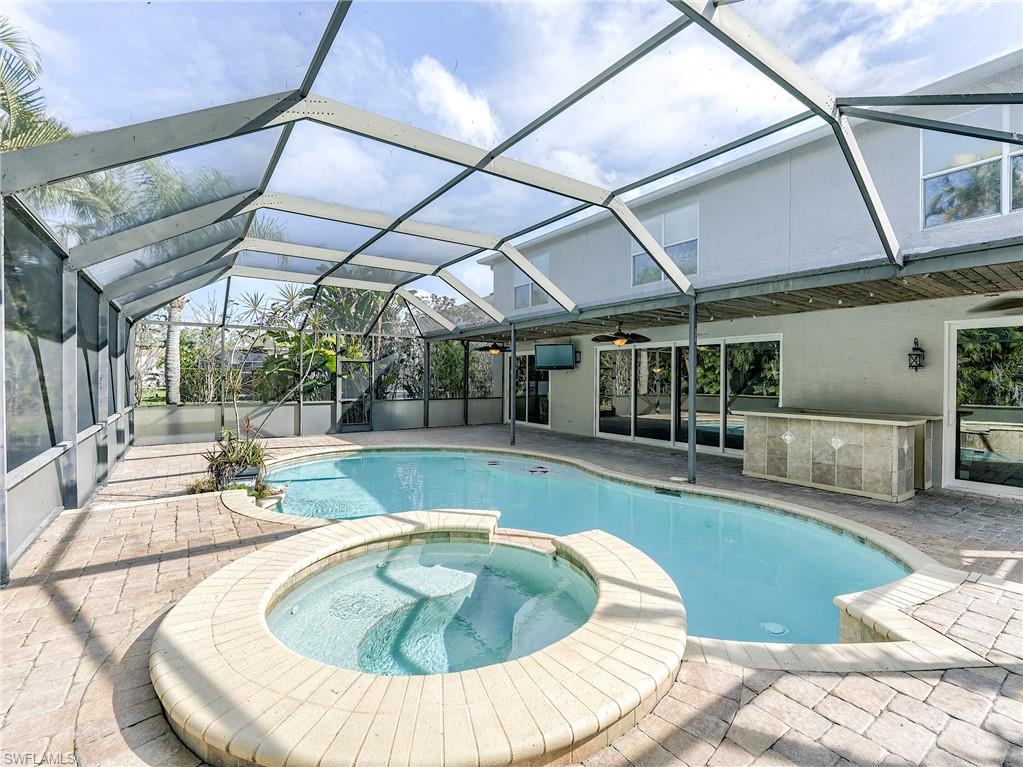 21281 Braxfield Loop Estero, FL 33928 - Photo 2 of 42 a view of a swimming pool with a patio