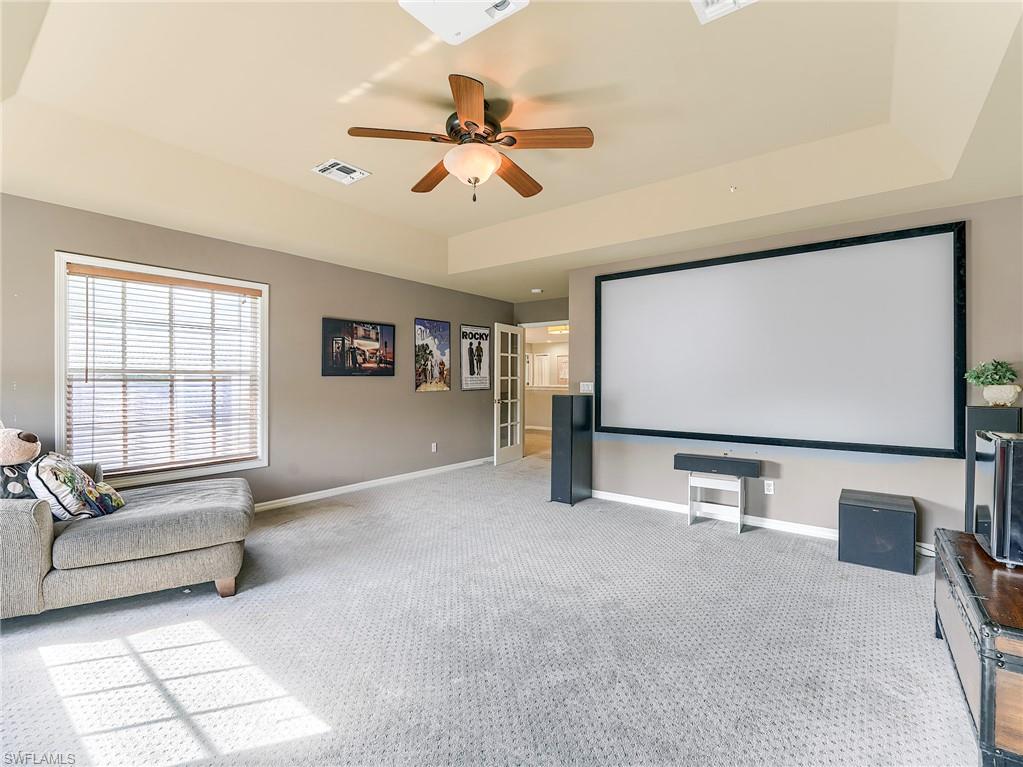 21281 Braxfield Loop Estero, FL 33928 - Photo 22 of 42 a living room with projector and a flat screen tv