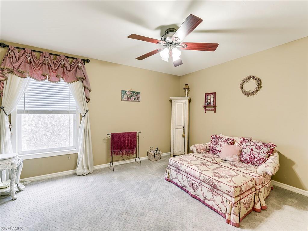 21281 Braxfield Loop Estero, FL 33928 - Photo 30 of 42 a bedroom with a bed and a chandelier