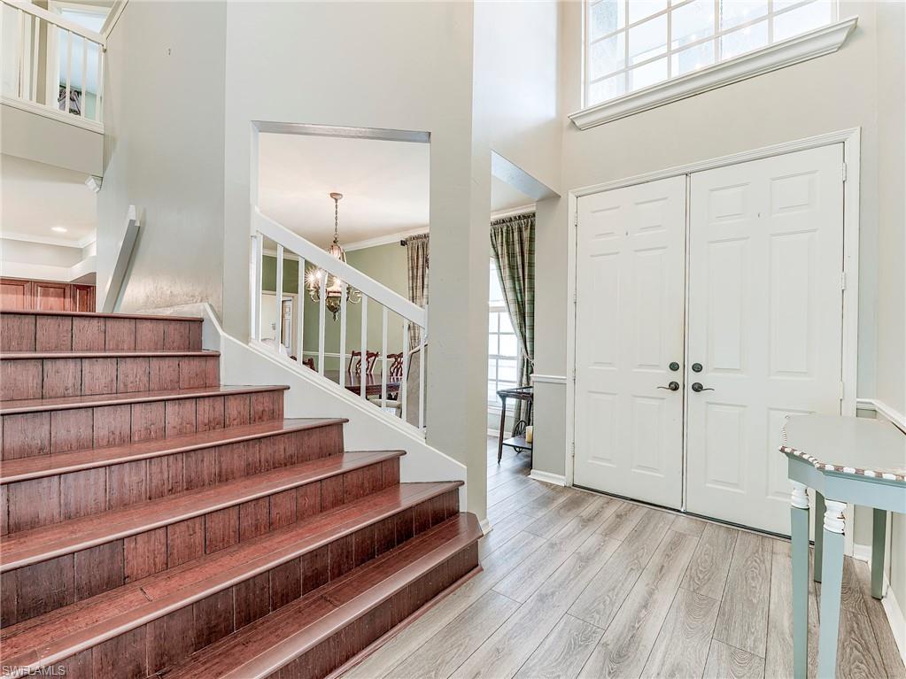 21281 Braxfield Loop Estero, FL 33928 - Photo 3 of 42 a view of staircase with white walls and wooden floor