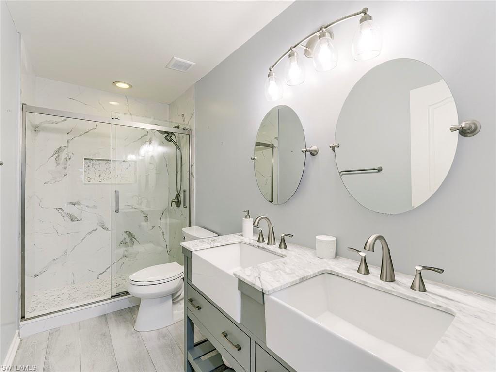 21281 Braxfield Loop Estero, FL 33928 - Photo 31 of 42 a bathroom with a double vanity sink mirror and toilet