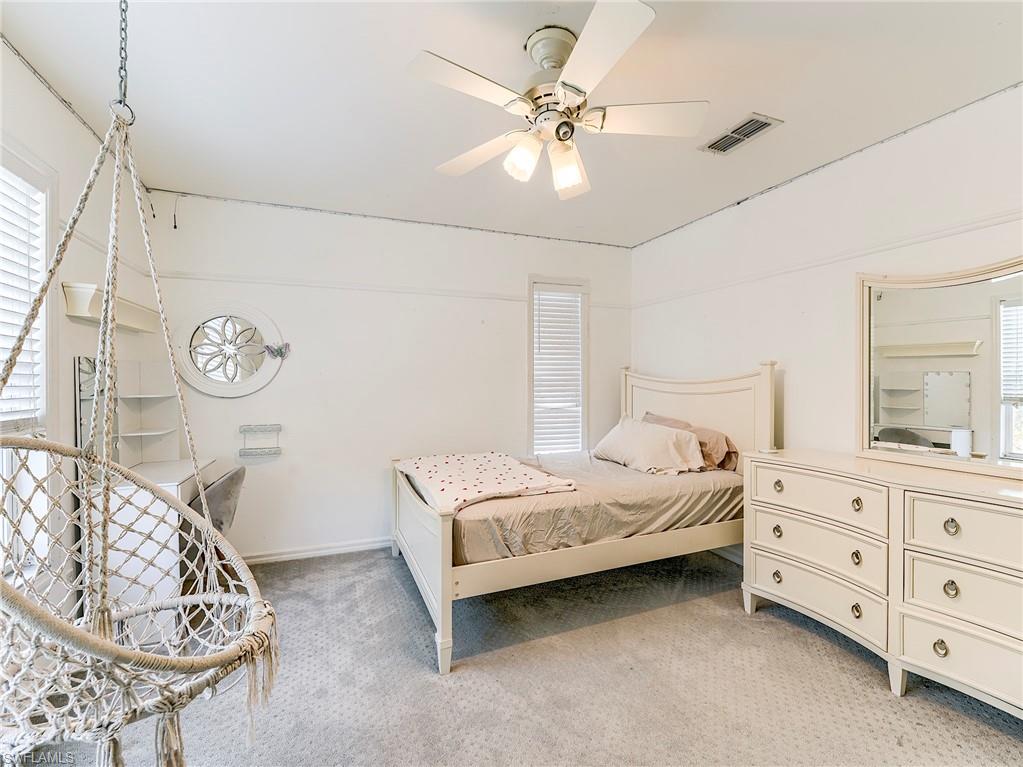 21281 Braxfield Loop Estero, FL 33928 - Photo 32 of 42 a bedroom with a bed and a chandelier