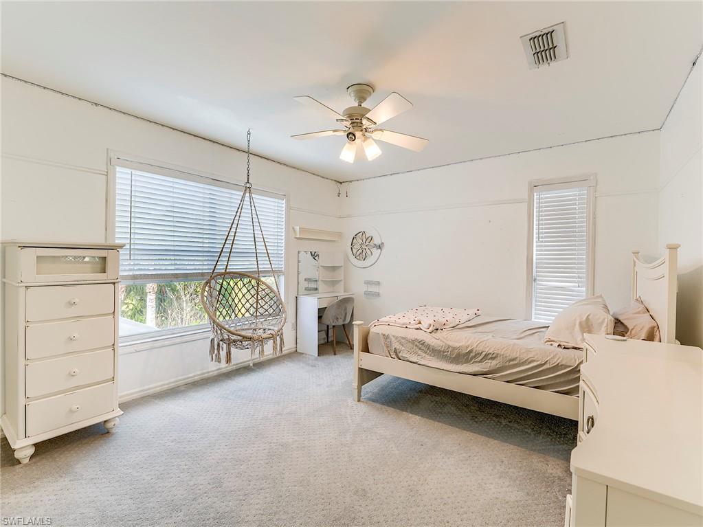21281 Braxfield Loop Estero, FL 33928 - Photo 33 of 42 a bedroom with a bed and a chandelier