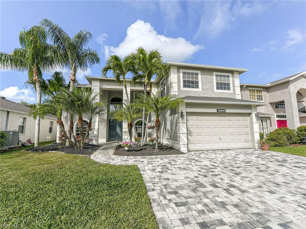 21281 Braxfield Loop Estero, FL 33928 - Photo 38 of 42 a front view of house with yard and trees around