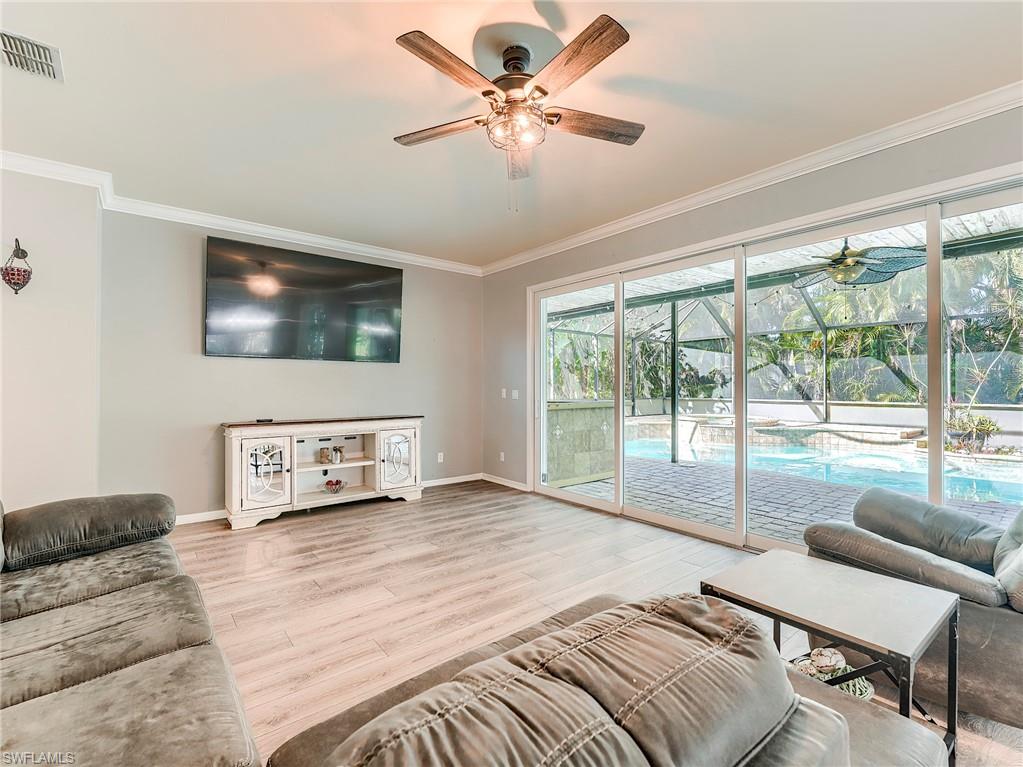 21281 Braxfield Loop Estero, FL 33928 - Photo 4 of 42 a spacious bedroom with a large bed and a flat screen tv