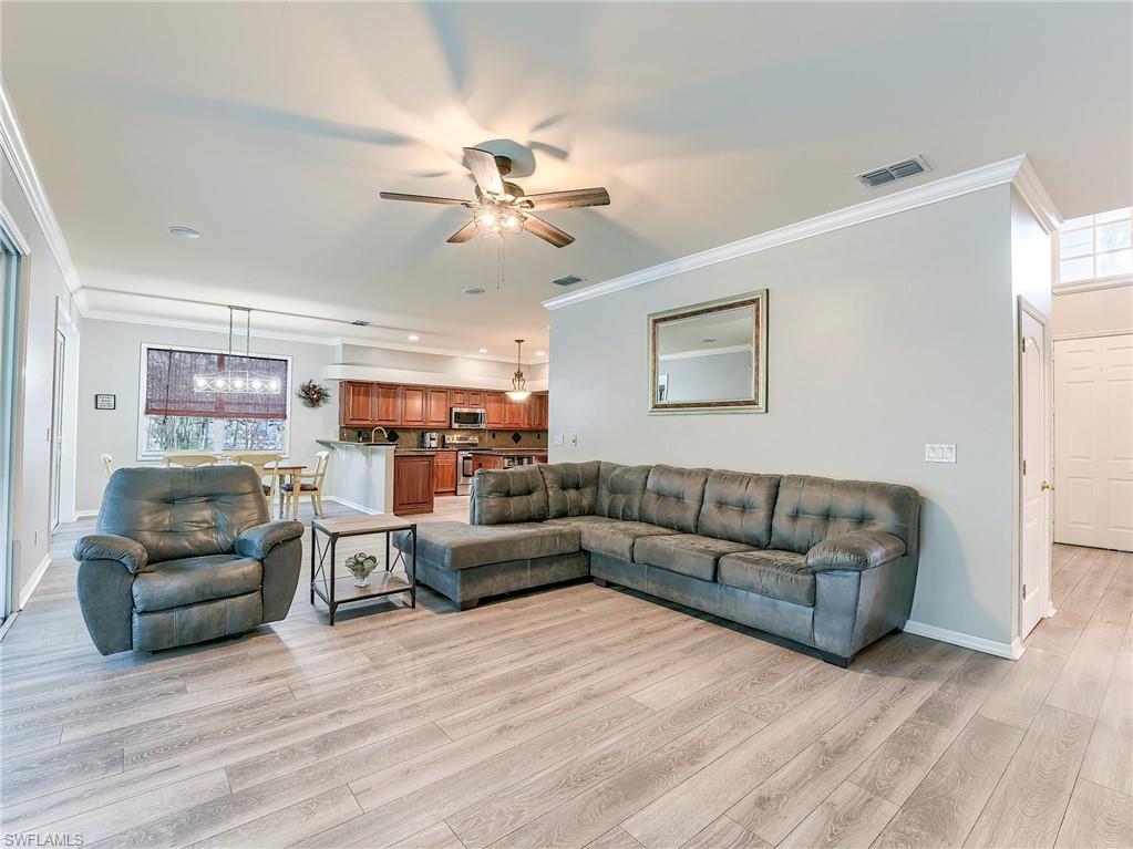 21281 Braxfield Loop Estero, FL 33928 - Photo 5 of 42 a living room with furniture and a wooden floor