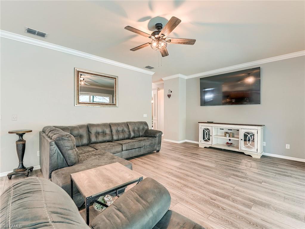 21281 Braxfield Loop Estero, FL 33928 - Photo 7 of 42 a living room with furniture and a flat screen tv
