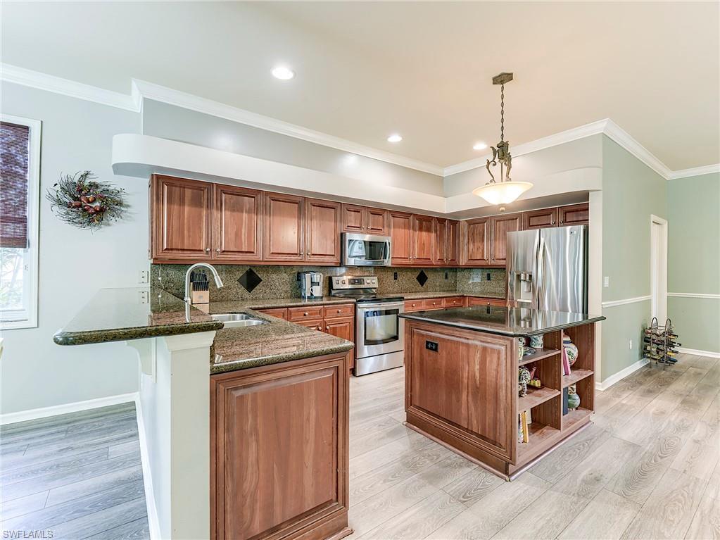 21281 Braxfield Loop Estero, FL 33928 - Photo 10 of 42 a kitchen with stainless steel appliances granite countertop a stove and a sink