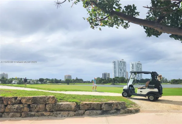 a view of a fountain in front of a house with a big yard