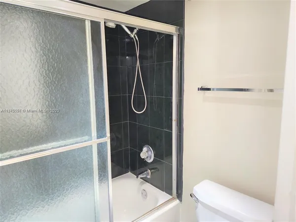 a bathroom with a shower and toilet