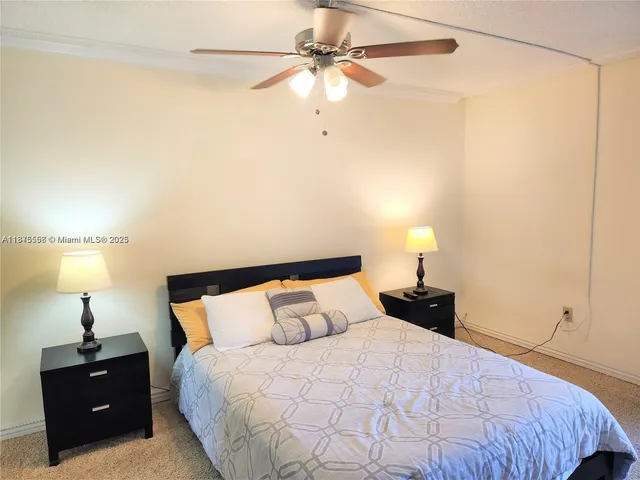 a bedroom with a bed and a lamp