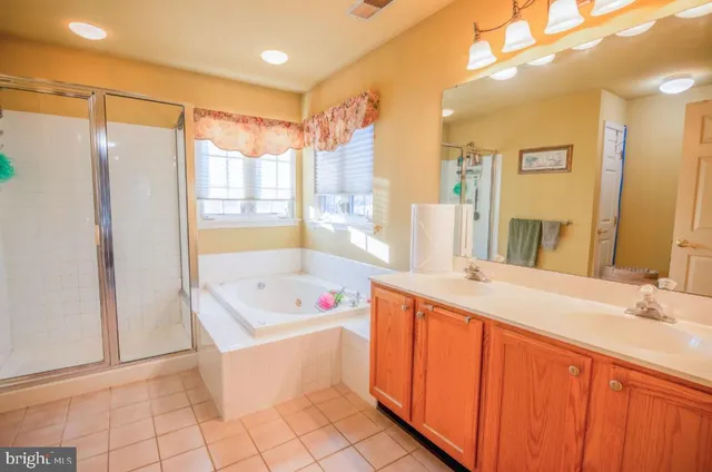 a bedroom with a bed and a dresser with mirror