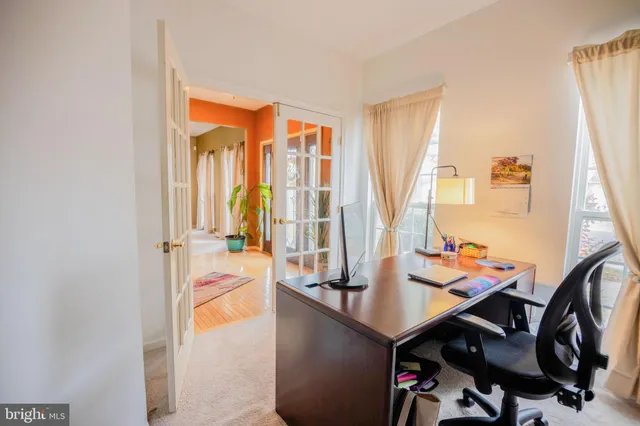 a kitchen with kitchen island granite countertop a stove a sink a refrigerator dining table and chairs with wooden floor