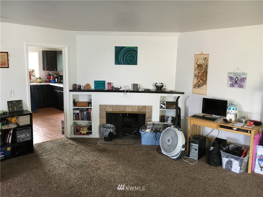 428 North Laventure Road Mount Vernon, WA 98273 - Photo 6 of 24 a living room with furniture a fireplace and flat screen tv