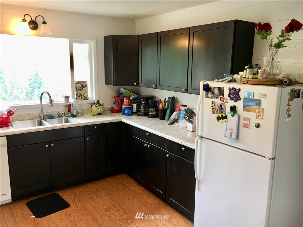 428 North Laventure Road Mount Vernon, WA 98273 - Photo 10 of 24 a kitchen with a sink refrigerator and cabinets