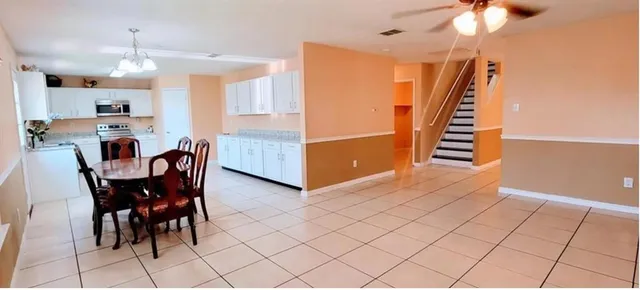 a dining room with furniture and wooden floor
