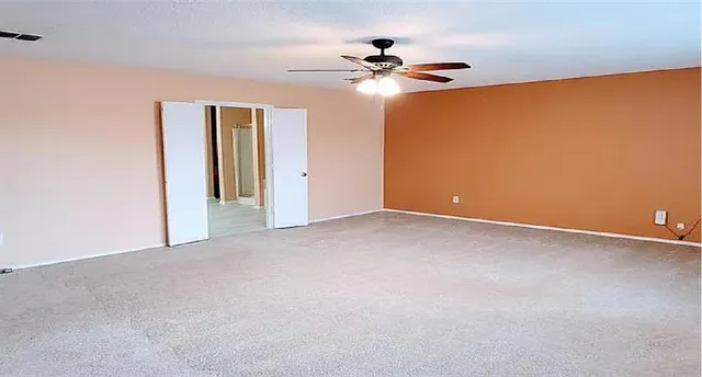 a view of an empty room with a fan