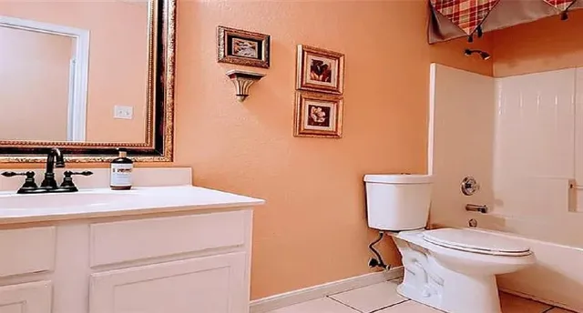 a bathroom with a sink toilet and mirror