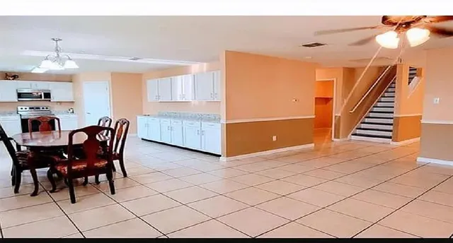 a dining room with furniture and wooden floor