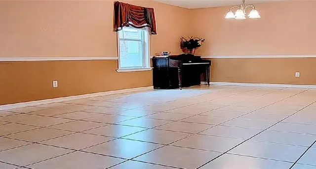 a view of a room with a cabinet and potted plants