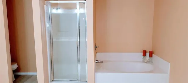 a white bath tub sitting next to a white toilet