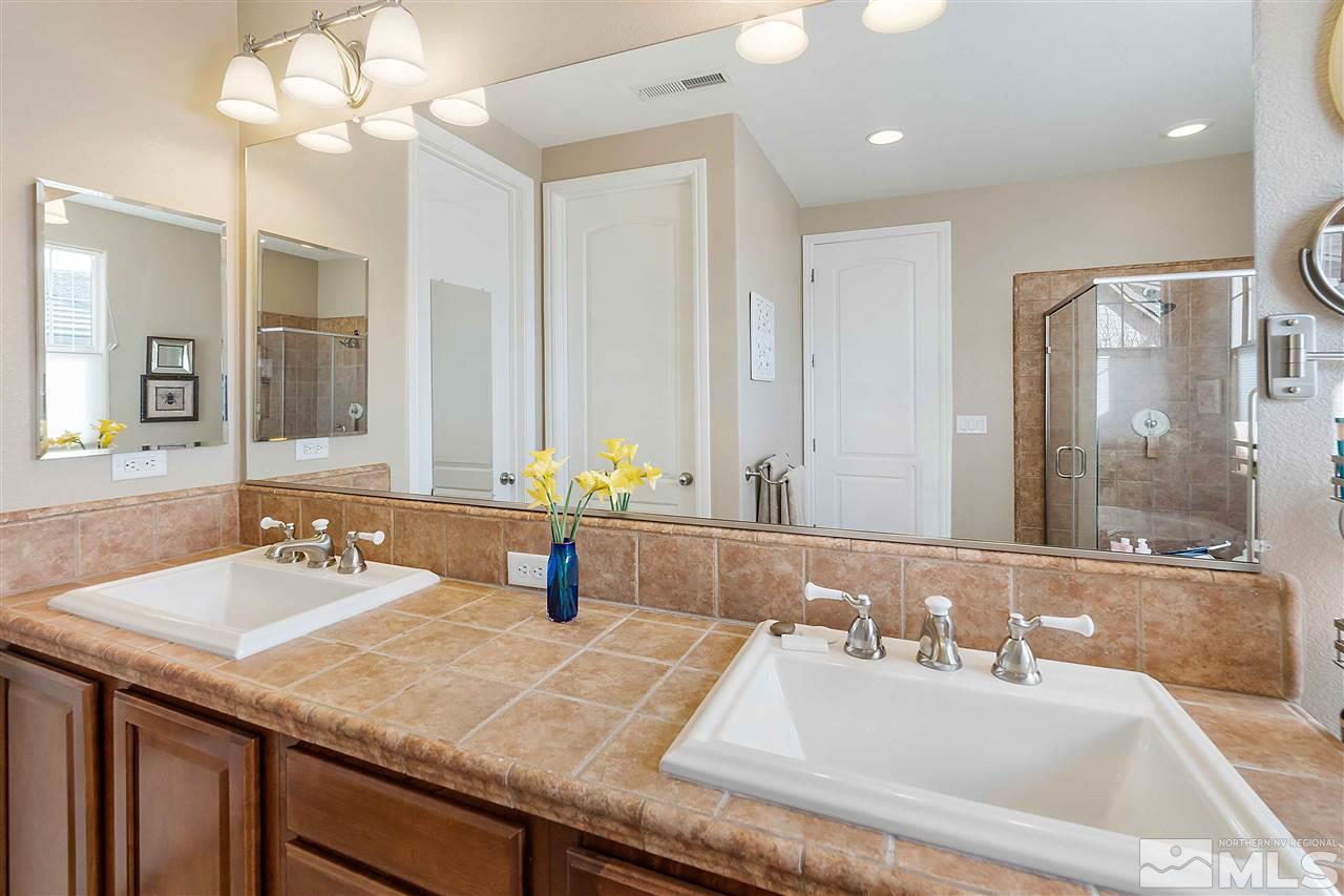 1680 Sawtooth Trail Reno, NV 89523 - Photo 18 of 24 a bathroom with a granite countertop sink a large mirror and a shower