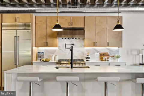 a kitchen with a sink and a refrigerator