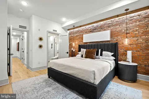 a bedroom with a bed and wooden floor