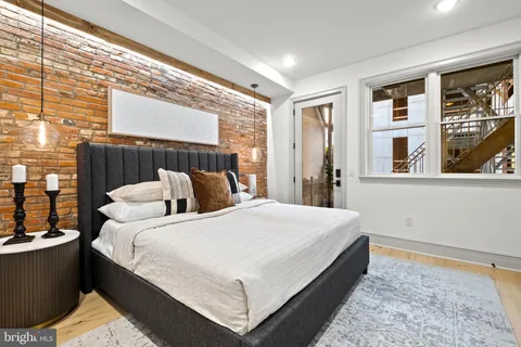 a large bed sitting in a bedroom next to a window