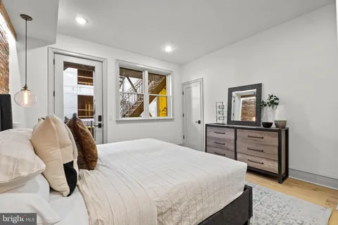 a bedroom with a bed and wooden floor