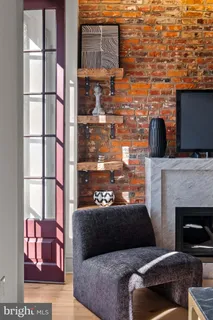 a living room with furniture a rug and a fireplace