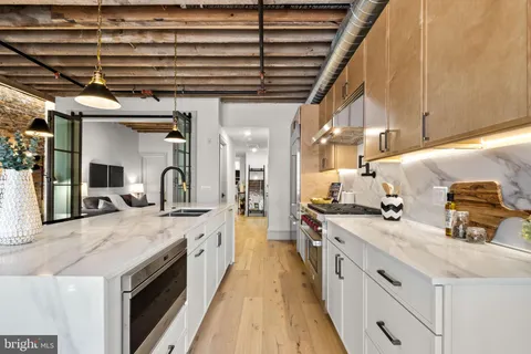 a large kitchen with a stove and cabinets