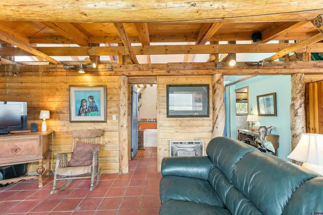 a room with furniture a ceiling fan and a window