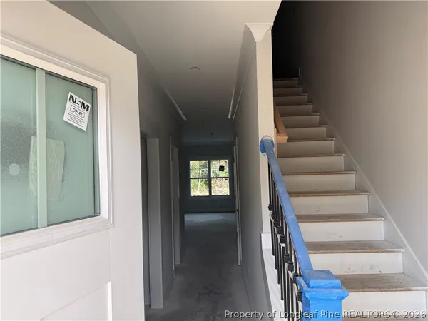 a view of entryway and hall with wooden floor