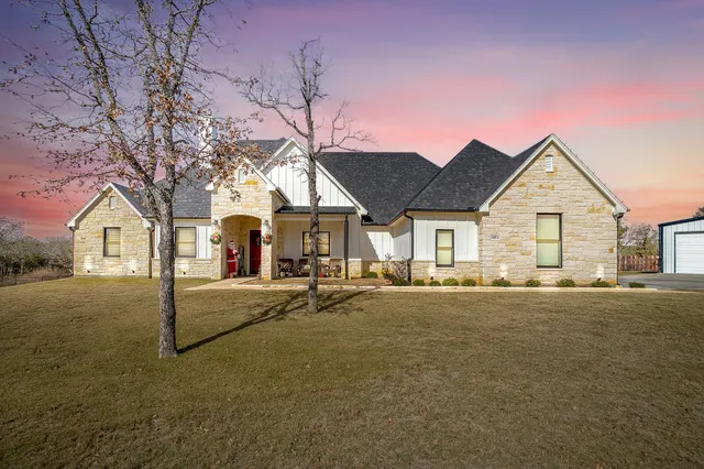 a view of a house with a yard and sitting area
