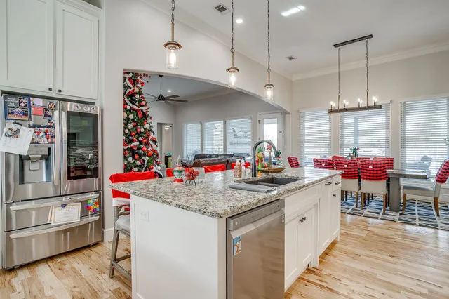 a kitchen that has a lot of cabinets and wooden floor