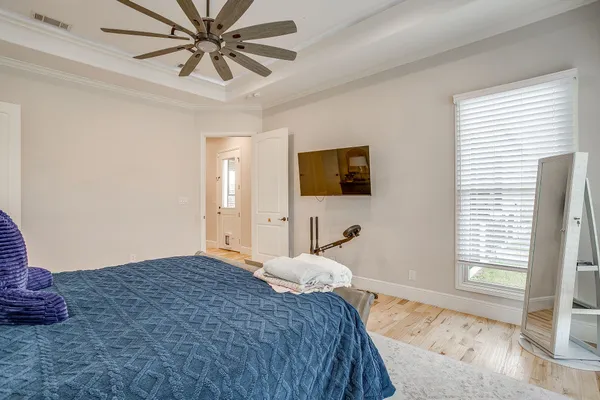 a bedroom with a bed and a flat screen tv