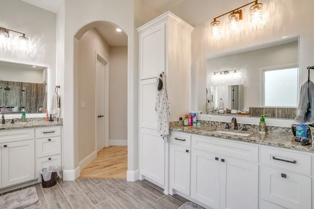 a bathroom with a double vanity sink and a mirror