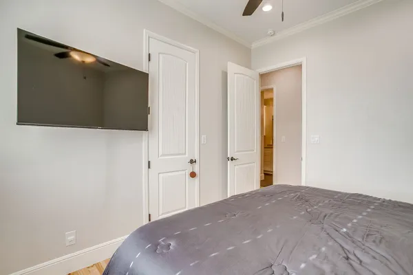 a bedroom with a bed and a flat screen tv