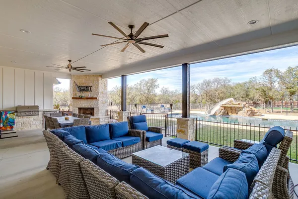 a living room with furniture a flat screen tv and a large window