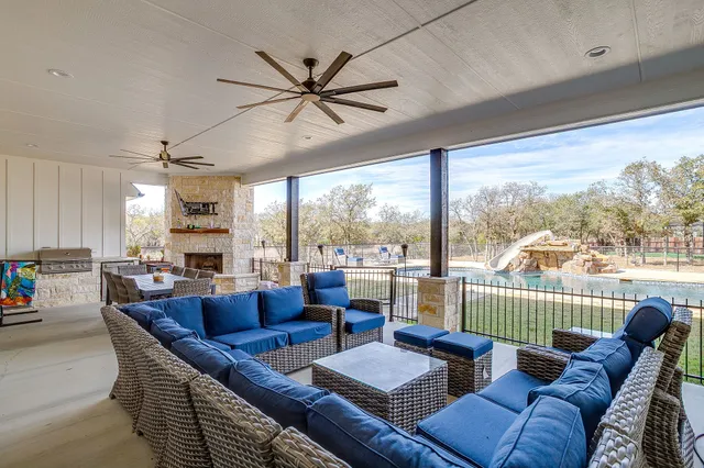 a living room with furniture a flat screen tv and a large window