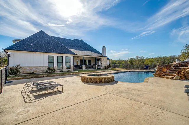 a view of a house with pool and ocean view