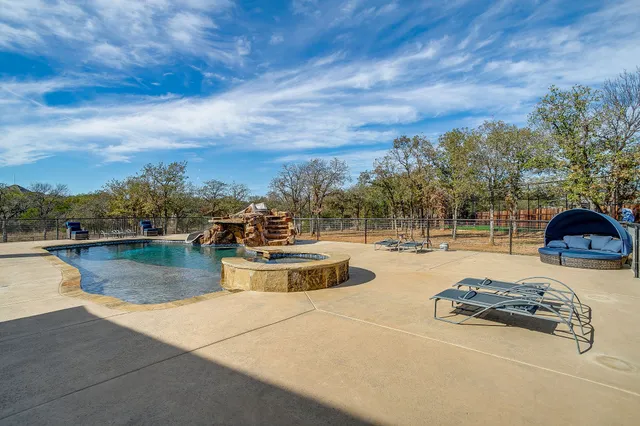 a view of a park with iron fence
